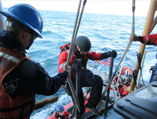 A DEPENDABLE law enforcement team member climbs on board the cutter following avessel boarding.